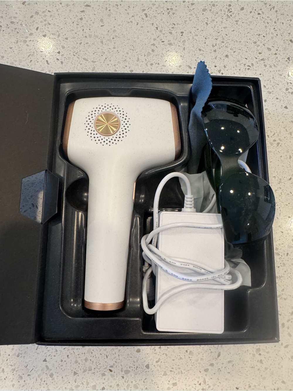 White Handheld Laser Hair Removal Device with Sunglasses